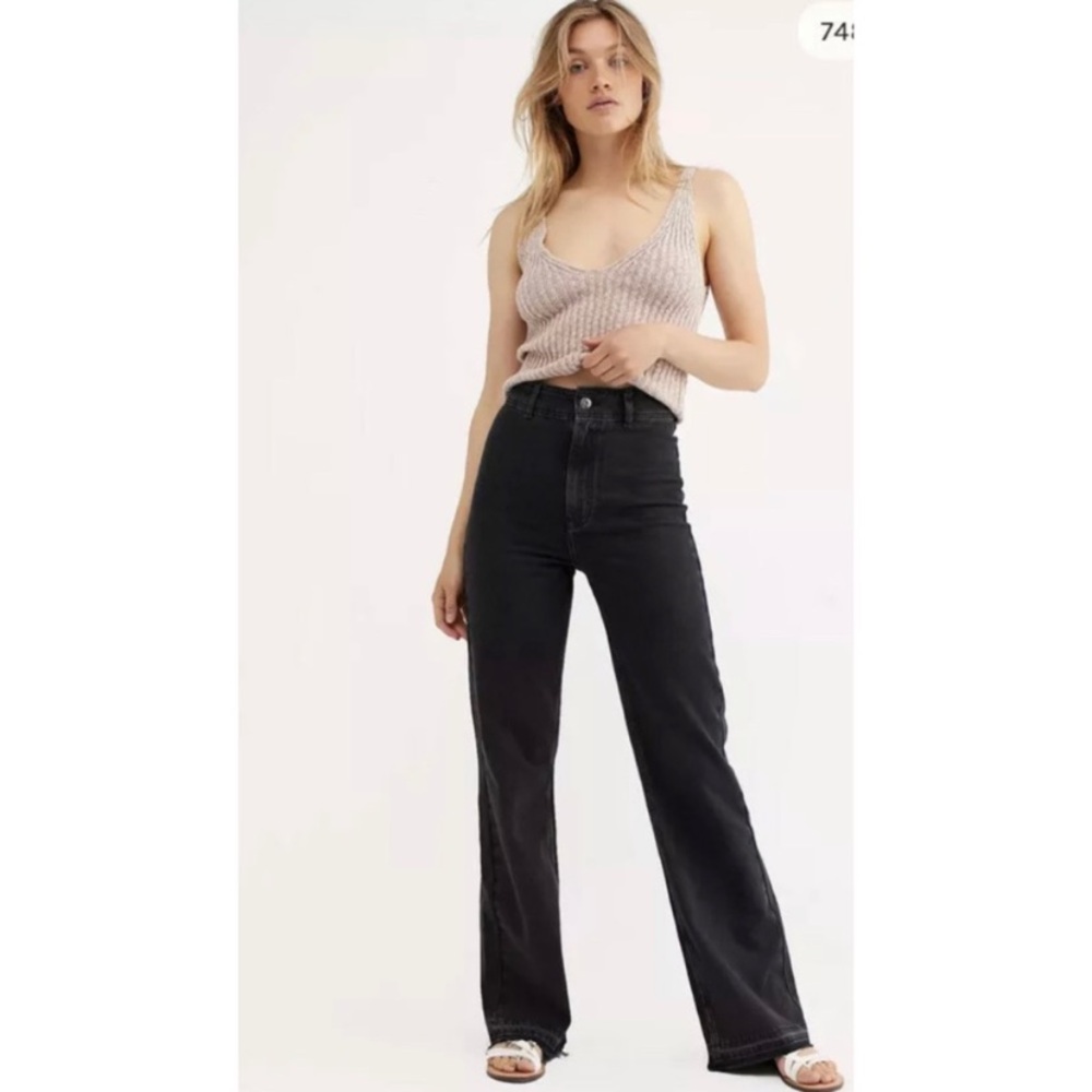 We the free black high-waisted, wide-leg jeans with a frayed or raw hem. Size 24